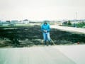 Ed Fuller finishing a strip of parking lot. 1995 looking east.